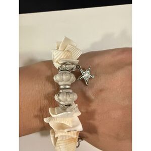 Beach-themed stretch seashell with silver-tone charms